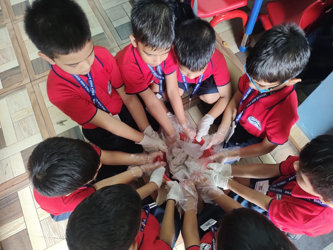 Joining hands to create newspaper bags